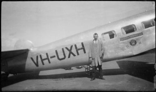 Unidentified many standing next to fuselage of Guinea Airways Lockheed L-10 Electra twin engine monoplane VH-UXH 'C.J. Levien', ca. 1940 [picture]