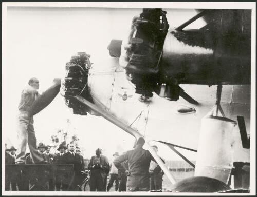 Captain George 'Scotty' Allan turning the propeller of Charles Ulm's Avro 618 Ten transport aircraft, VH-UXX, Faith in Australia, 1933 [picture]