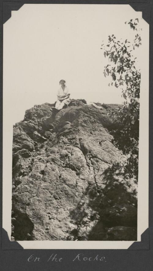 Mattie Yonge sitting on top of a rocky outcrop, Snapper Island, Queensland, ca. 1928 [picture]