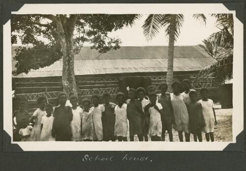 Group of school children stand out the front of the school on Badu Island, Queensland, ca. 1928 [picture] / Charles Maurice Yonge