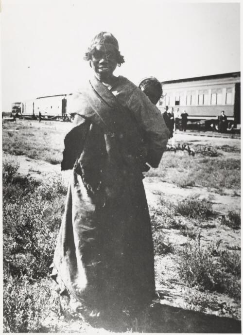 Aboriginal woman carrying a child in a sling on her back, Wynbring, South Australia, 1921 [picture]