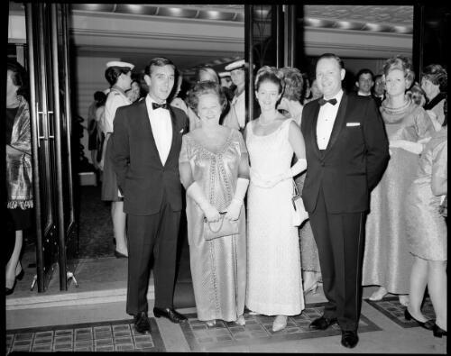 Unidentified group of people in the doorway to the Hoyts Century Theatre at the preview of Camelot, Sydney, 20 December, 1967 [2] [picture] / John Mulligan