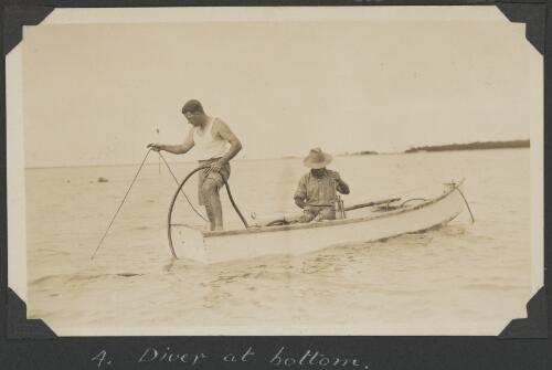 Two men in a boat manning the air hose for a diver below, Low Islands, Queensland, ca. 1928 [picture] / C.M. Yonge
