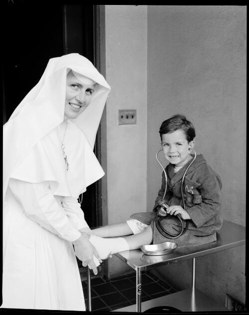 Sister Paulina Pilkington bandaging a young boy's ankle at St. Vincent's General Hospital, Sydney, 4 September, 1963 [1] [picture] / John Mulligan