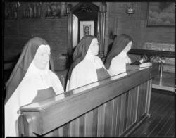 Three unidentified nuns praying in the chapel of the Carmelite ...