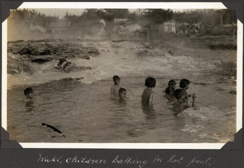 Children bathing in a hot pool at Waki, Rotorua, New Zealand, 1929 [picture] / C.M. Yonge