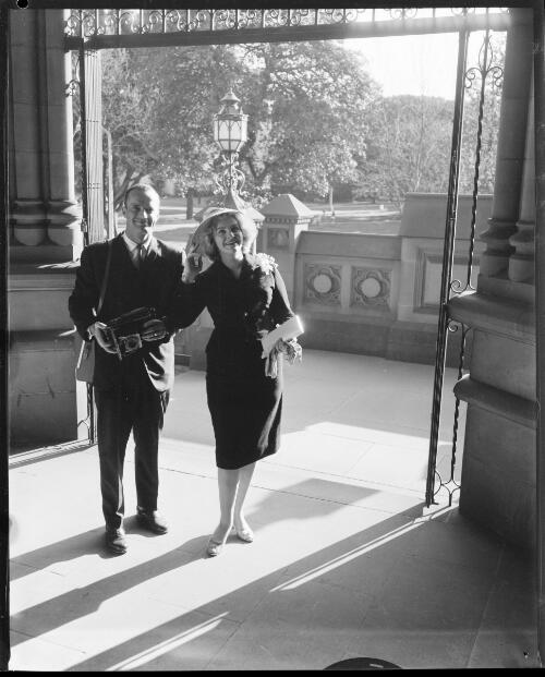 Two unidentified American tourists in the entrance to St. Mary's Cathedral, Sydney, 5 September, 1962 [2] [picture] / John Mulligan