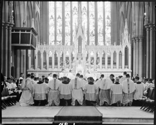 New priests kneeling before the altar during their ordination during first mass at St. Mary's Cathedral, Sydney, 19 July, 1963 [picture] / John Mulligan