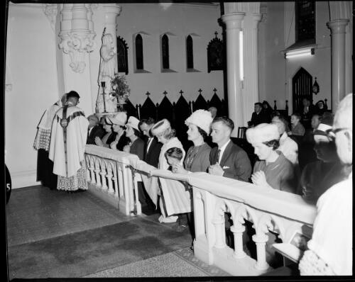 Two unidentified priests serve communion to parishioners during first mass at St. Mary's Cathedral, Sydney, 19 July, 1963 [picture] / John Mulligan