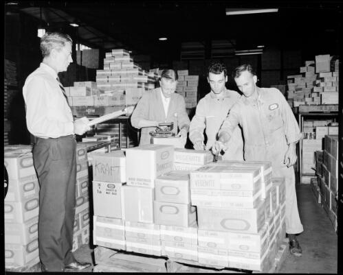 Three unidentified warehouse workers and a supervisor checking boxes on a pallet at the Kraft plant, Lilyfield street, Leichhardt, 21 March, 1968 [picture] / John Mulligan