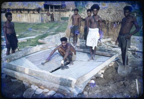 Medical officer Hubert Murray with his construction team building a latrine, Saiho, Papua New Guinea, 1951 [transparency] / Albert Speer