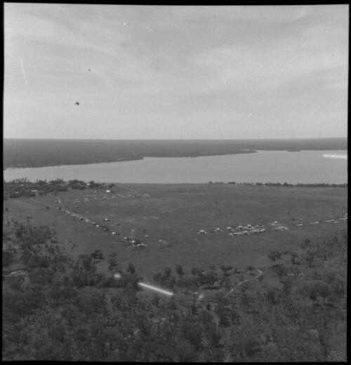 Aerial view of coastline and habitations, Bathurst and Melville Islands, Northern Territory [2] [picture] / John Mulligan