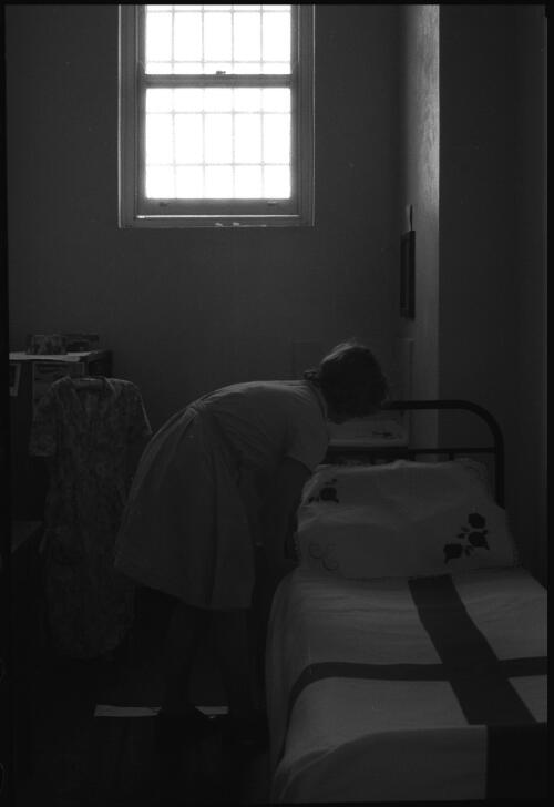 Prisoner making bed in cell, State Reformatory for Women, Long Bay, Sydney [2] [picture] / John Mulligan