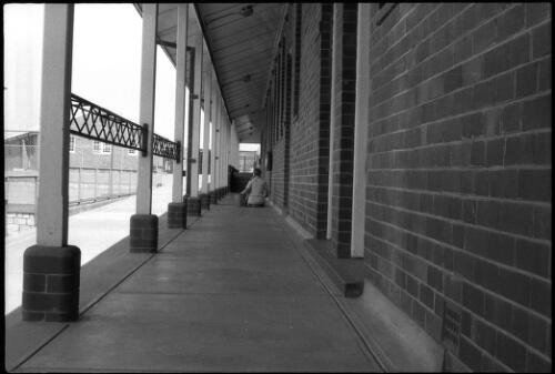 Prisoner on knees scrubbing verandah floor, State Reformatory for Women, Long Bay, Sydney [1] [picture] / John Mulligan
