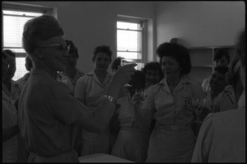 Unidentified woman with a group of prisoners holding wine glasses, State Reformatory for Women, Long Bay, Sydney [2] [picture] / John Mulligan