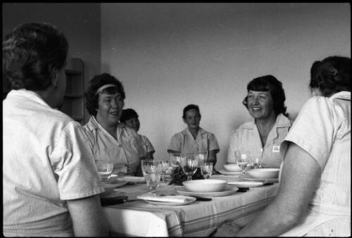 Group of prisoners seated at formal dining table, State Reformatory for Women, Long Bay, Sydney [1] [picture] / John Mulligan