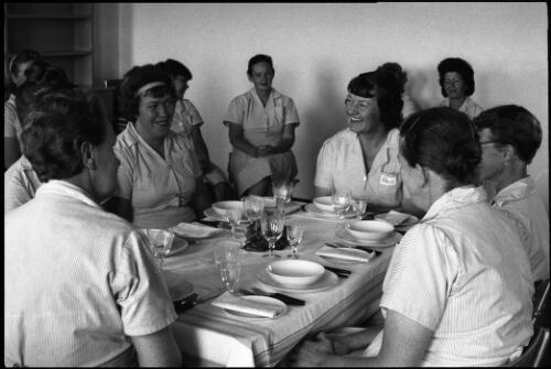 Group of prisoners seated at formal dining table, State Reformatory for Women, Long Bay, Sydney [2] [picture] / John Mulligan