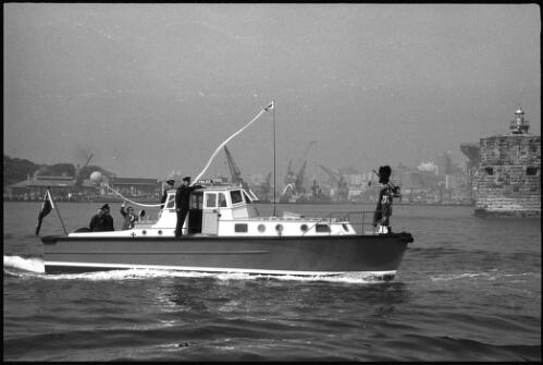 Police launch Nemesis cruising on Sydney Harbour with unidentified piper in bow, 6 June 1966 [1] [picture] / John Mulligan