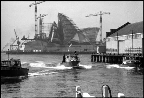 Police launch Nemesis cruising on Sydney Harbour with unidentified piper in bow and Sydney Opera House under construction in background, 6 June 1966 [picture] / John Mulligan