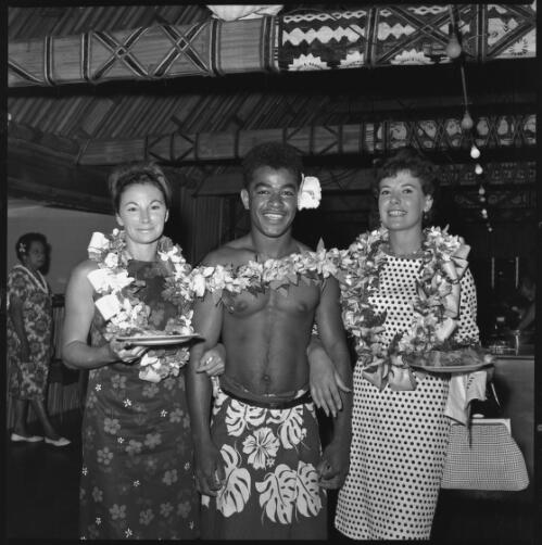 Miss Maglia, on right, and unidentified woman posing with Fijian man, Suva, Fiji, 22 February 1966 [picture] / John Mulligan