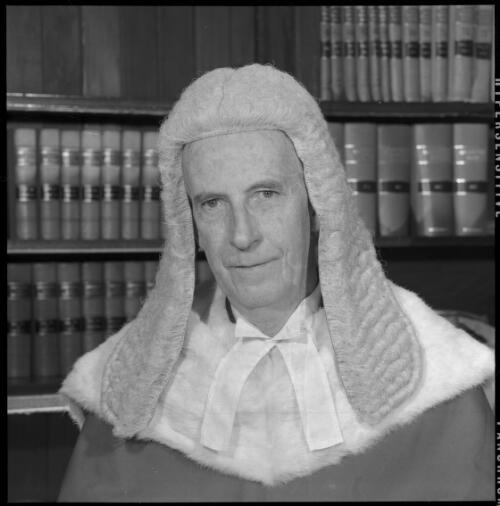 Portrait of Mr Justice Cyril Ambrose Walsh wearing judicial robes and wig seated in chambers, 20 May 1965 [6] [picture] / John Mulligan