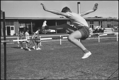 St. Edmund's School for Blind Boys student Phil Scarf competing in the high jump event at the 14th Annual Combined Blind Schools Sports, North Rocks School for Blind Children, Sydney, 14 August 1965 [3] [picture] / John Mulligan