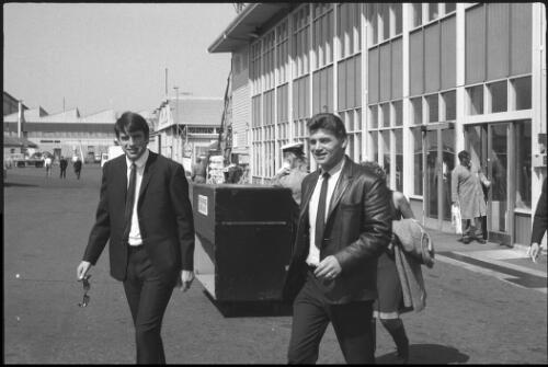 Con Cluskey of the musical group "The Bachelors", and unidentified man leaving a building at Mascot Airport, Sydney, 27 September 1965 [picture] / John Mulligan