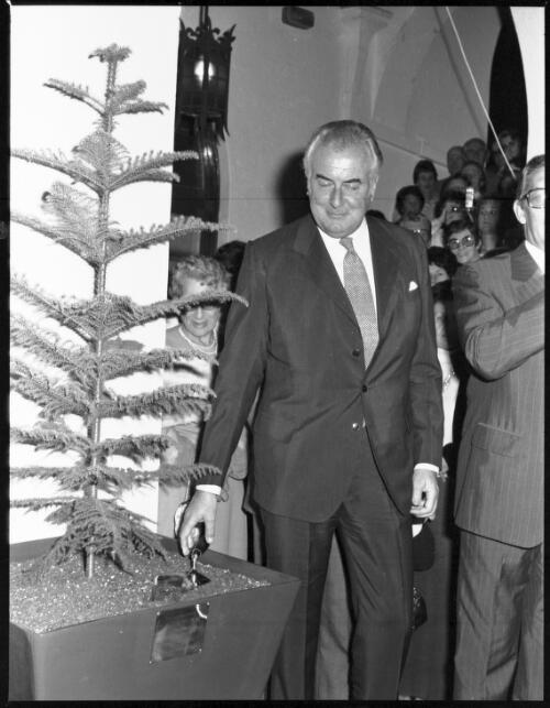 Gough Whitlam turning the turf in a potted tree in front of crowd at the opening of Roxy Theatre, Hoyts, George Street, Parramatta, 1976 [3] [picture] / John Mulligan