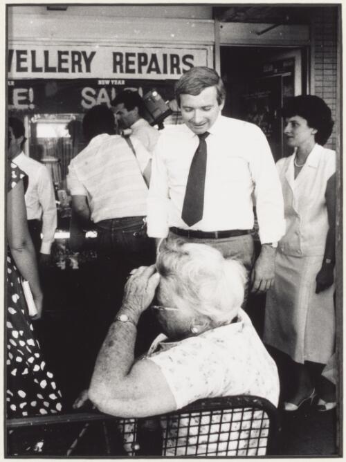 Nick Greiner accosts a staunch labour supporter at a bus stop in Beamish Street, Campsie, during rallying for a by-election in January, ca. 1984 [2] [picture] / photo by Peter Solness