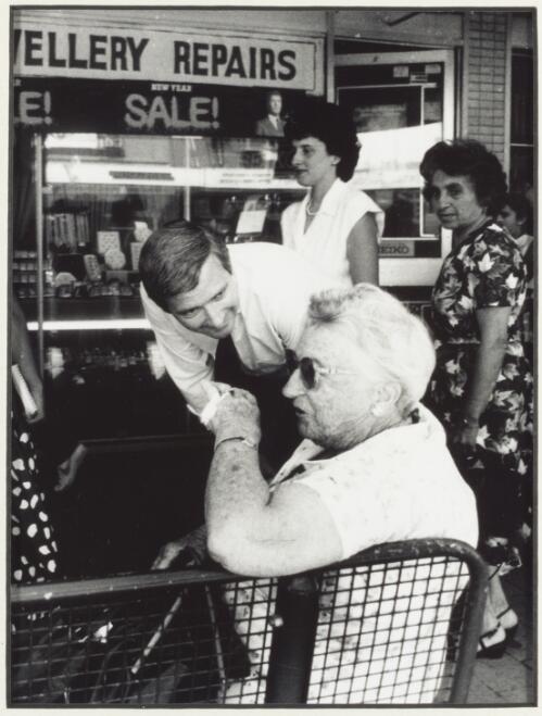 Nick Greiner accosts a staunch labour supporter at a bus stop in Beamish Street, Campsie, during rallying for a by-election in January, ca. 1984 [3] [picture] / photo by Peter Solness