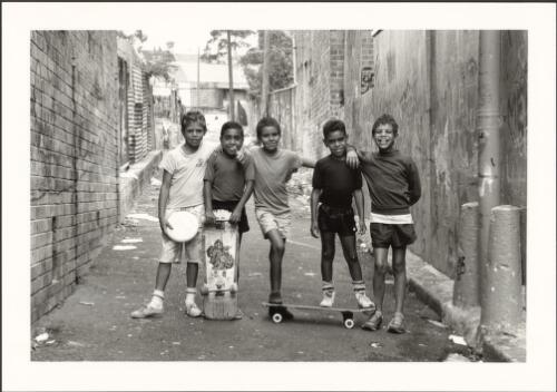 Eveleigh Alley: the alley behind the Aboriginal Housing Co-operative, Eveleigh St., Redfern in Sydney, 1989. [Five Aboriginal boys] [picture] / Mark Tedeschi