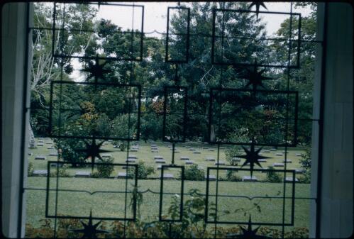Bomana Cemetery, through a wrought iron window (towards the left) Port Moresby, Papua New Guinea, 1953 [picture] / Terence and Margaret Spencer