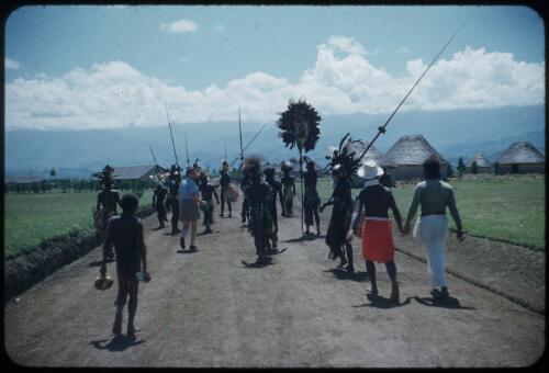 We set off: Marie Reay, the anthropologist, in shorts, Binda (our haus boi in red laplap Wahgi Valley, Papua New Guinea, 1955 [picture] / Terence and Margaret Spencer