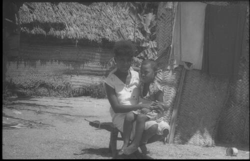 Woman sitting on a coconut scraping stool Carteret Islands, Papua New Guinea, 1960 [picture] / Terence and Margaret Spencer