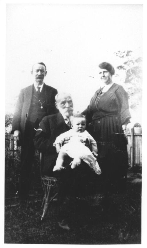 [Anderson family photograph showing a seated elderly man holding a baby and a man and woman standing] [picture]