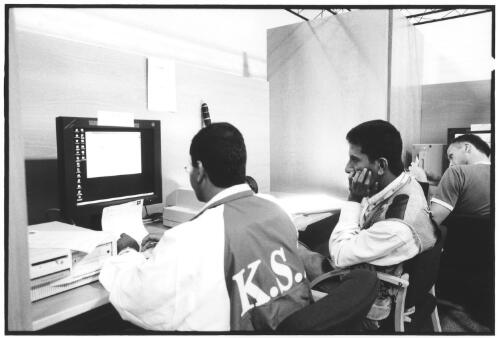 Photographers using computer terminals in the photo services area for scanning, cropping, captioning and transmission of images, Kodak Image Centre, Outback Pavilion, Main Press Centre, [Sydney 2000 Olympics], Homebush Site, September 2000 (1) [picture] / Brian Leonard