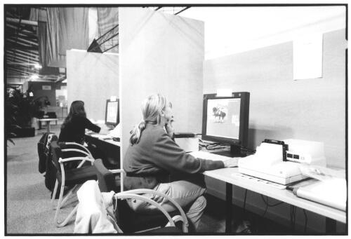 Photographers using computer terminals in the photo services area for scanning, cropping, captioning and transmission of images, Kodak Image Centre, Outback Pavilion, Main Press Centre, [Sydney 2000 Olympics], Homebush Site, September 2000 (2) [picture] / Brian Leonard