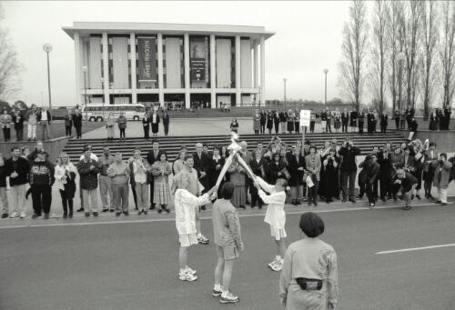 The Olympic Torch changes hands in front of the National Library of Australia, 2000 [picture] / Greg Pook