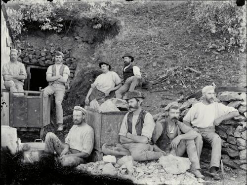 [Eight unidentified miners at mine entrance with two ore cars, New South Wales] [picture] / Robert Morse Withycomb