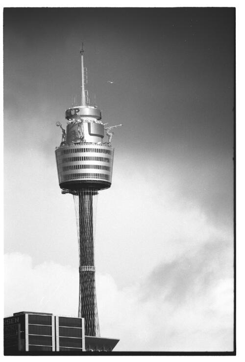 The AMP Sydney Tower with the Olympic theme sculptures, Sydney CBD, 24 September 2000 [picture] / Loui Seselja