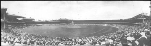 Panoramic view of Melbourne Cricket Ground, cricketers on the field with a full crowd, 1936/37 Marylebone Cricket Club (MCC) tour of Australia [transparency]
