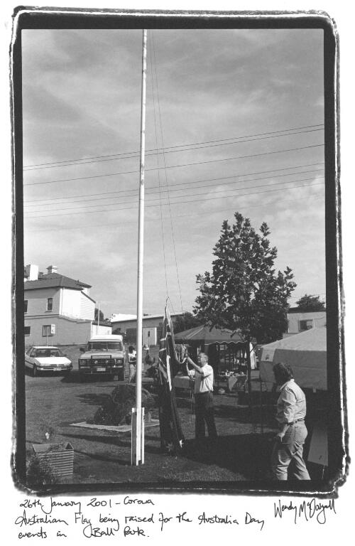 Australian flag being raised for the Australia Day events in Ball Park, 26th January 2001, Corowa [picture] / Wendy McDougall