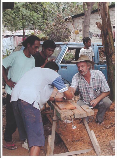 [David Pepper, Australian International Volunteer from Sydney, kneeling in front of trees, teaching carpentry, Dili, East Timor on Sept. 3-4, 2001] [picture] / Francis Reiss