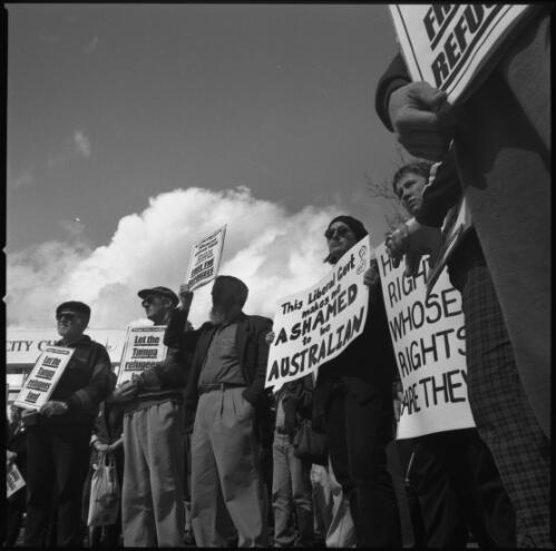 [Line of demonstrators holding placards to express their shame to be Australian over the Federal Liberal Party's policy and treatment of refugees, Garema Place, Civic, Canberra on Aug. 31, 2001] [picture] / Loui Seselja