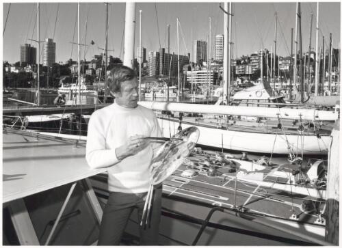 Mr Baigent at work on his floating studio, the motor cruiser Leisure Lady, at Rushcutters Bay, Sydney [picture] / Australian Information Service photograph by John Tanner