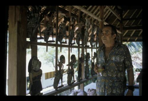 Donald Friend in one of the houses on his property, Bali, 1975, 1 [transparency] / Ross Dearing