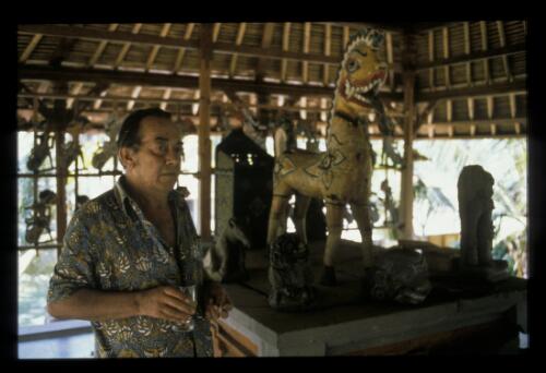 Donald Friend in one of the houses on his property, Bali, 1975, 2 [transparency] / Ross Dearing