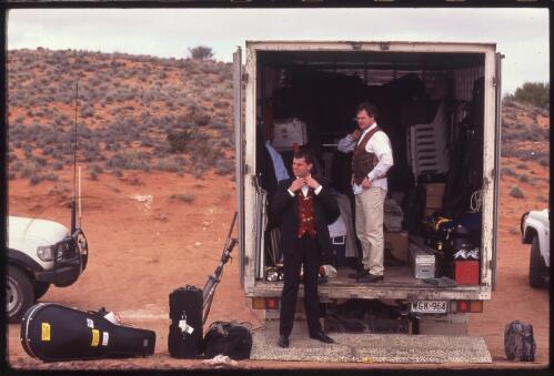 Australian String Quartet members, Niall Brown (left) and James Cuddeford change in to their suits for filming a dream sequence on the white salt plains of Lake Hart, for an ABC documentary of their 1999 tour of outback South Australia [picture] / Ian Kenins