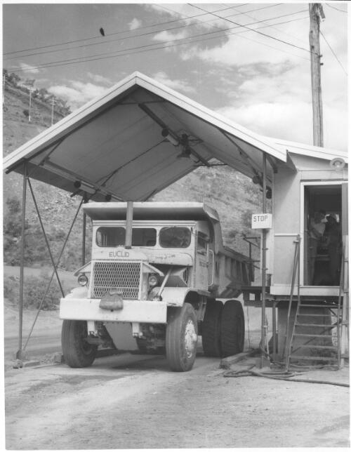 Truck with a load of ore stopping on the way to the mill, checking the radioactive content, Mary Kathleen uranium mine, ca. 1959 [picture] / Robin V. F. Smith
