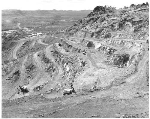 The stepped-face of the Mary Kathleen mine with the processing plant showing in the background, ca. 1959 [picture] / Robin V. F. Smith